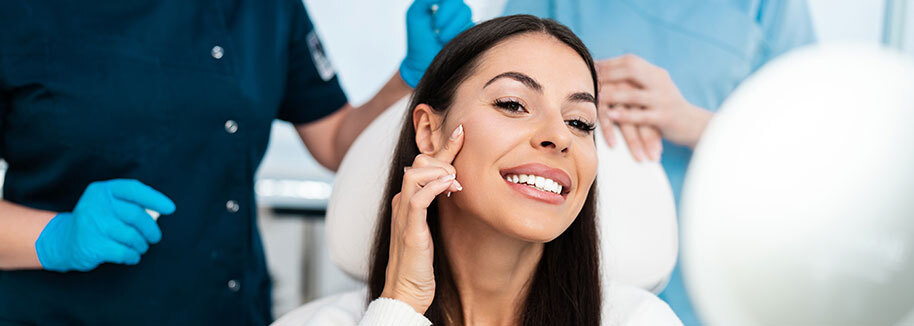 Woman smiling and admiring her smooth, wrinkle-free skin