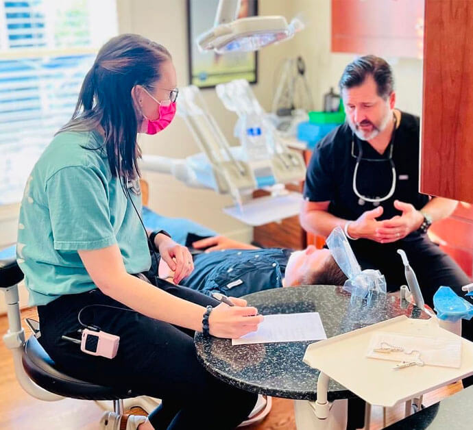 dentist and staff member with a patient