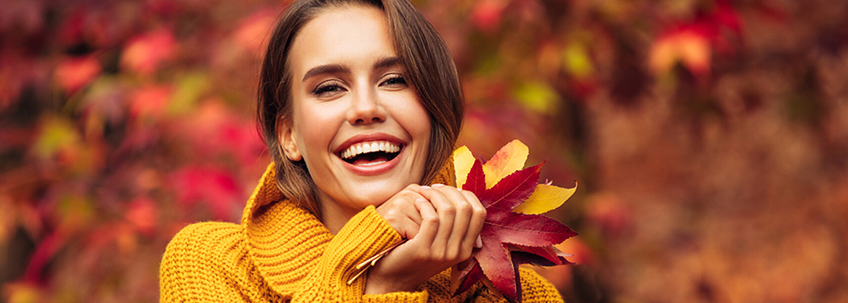 smiling woman holding leaves