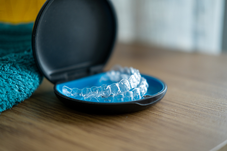 Transparent Invisalign teeth aligners in a case.