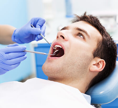 man receiving a dental exam
